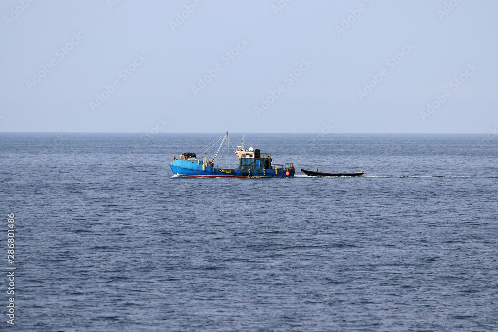 Fishing boats moving in sea.