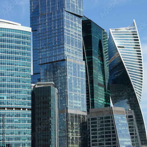 Business in Russia, fragment of modern business center buildings on blue sky background