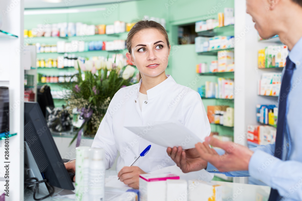 Pharmacist helping client choose medicine