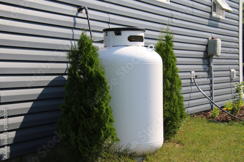 A large propane tank on the side of a house photo