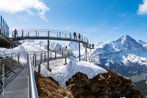 Traveller are resting and photograph on sky cliff walk at First peak of Alps mountain Grindelwald Switzerland photo