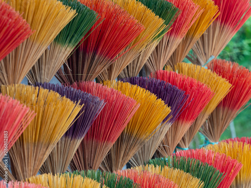 Close Up of Bundles of Colorful Incense Sticks in Vietnam photo
