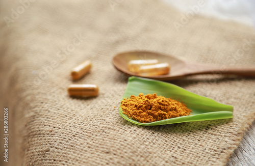 Fototapeta Naklejka Na Ścianę i Meble -  Herbal capsules from organic turmeric herb for health care eating 
