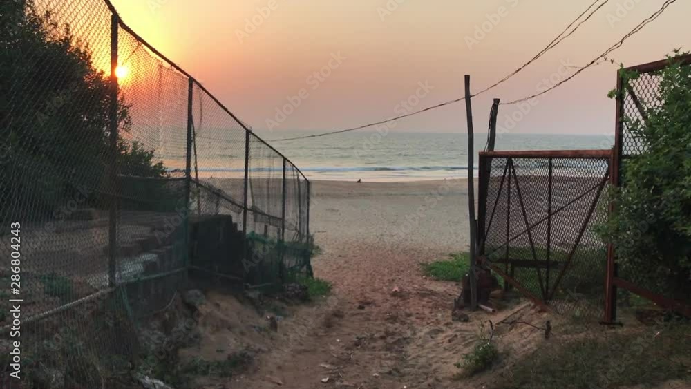 Pathway leading to the beach. Sunset at Candolim Beach, Goa, India. Pathway leading to the beach. Sunset at Candolim Beach, Goa, India.