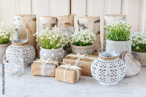 Beautifully wrapped gifts and flowers in the background