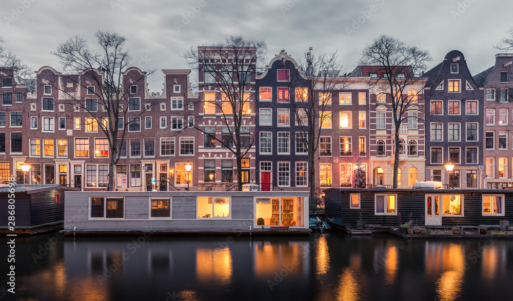 Traditional Dutch buildings and houseboats along the canals of Amsterdam, Netherlands