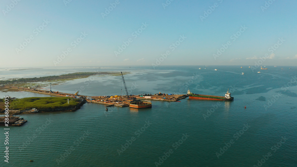 Seaport with cranes and harbor with cargo ships, Cebu City, Philippines. Ships in industrial port. Seaport with cranes and harbor with cargo ships, Cebu City, Philippines. Ships in industrial port.