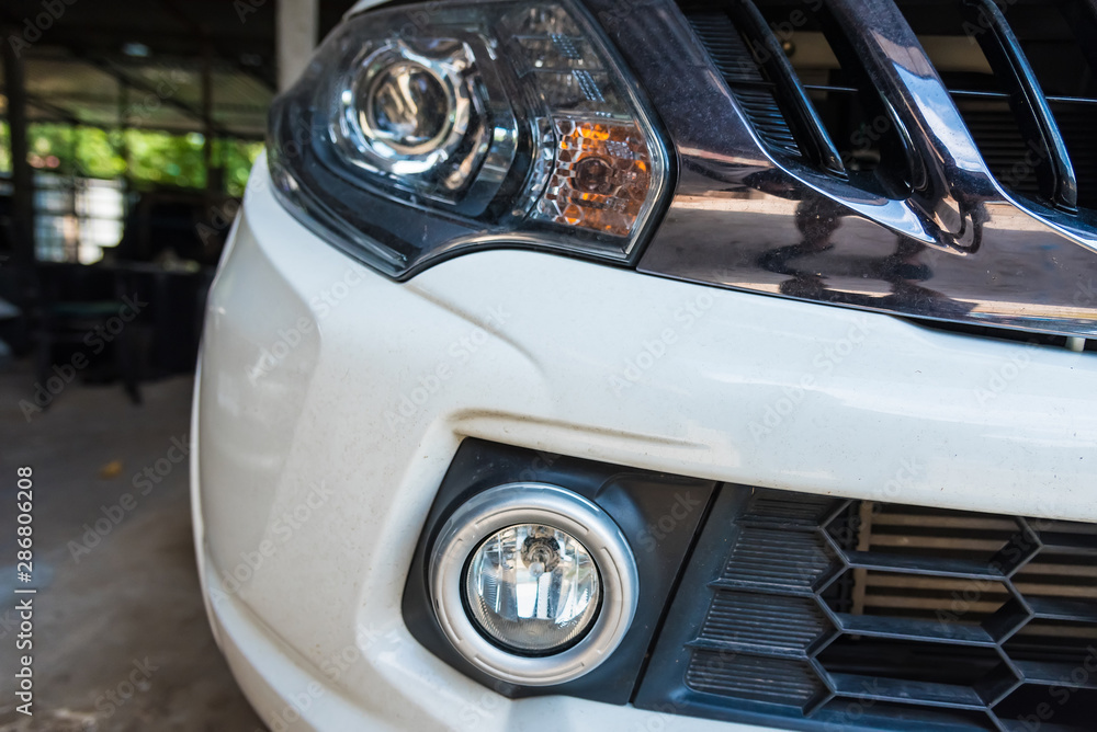 Closeup of front view of a white car modern technology head light with xenon lamp.