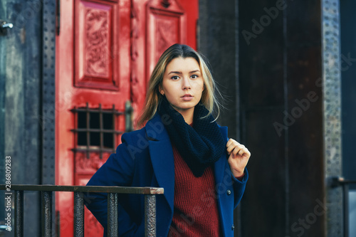 Beautiful young girl in coat and sweater in town © fisher05