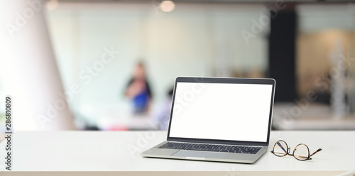 Open blank screen laptop computer with blurred background