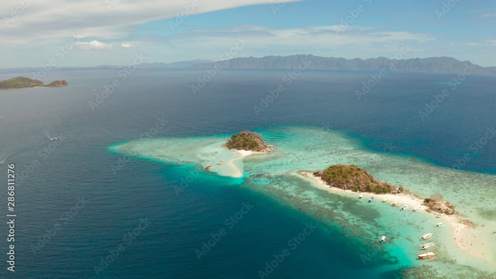 aerial seascape island with white beach. Bulog Dos, Philippines, Palawan. tourist boats on coast tropical island. Seascape bay with turquoise water and coral reef. aerial seascape island with white beach. Bulog Dos, Philippines, Palawan. tourist boats on coast tropical island. Seascape bay with turquoise water and coral reef.