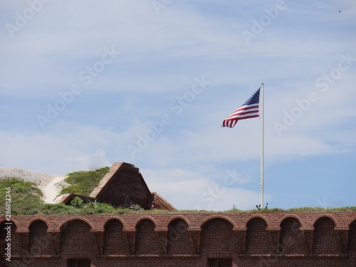 View of the top of Fort Jefferson, Dry Tortugas National Park, with a United States flag flying from a pole.