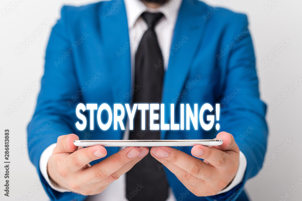 Handwriting text writing Storytelling. Conceptual photo activity writing stories for publishing them to public Businessman in blue suite with a tie holds lap top in hands Handwriting text writing Storytelling. Conceptual photo activity writing stories for publishing them to public Businessman in blue suite with a tie holds lap top in hands