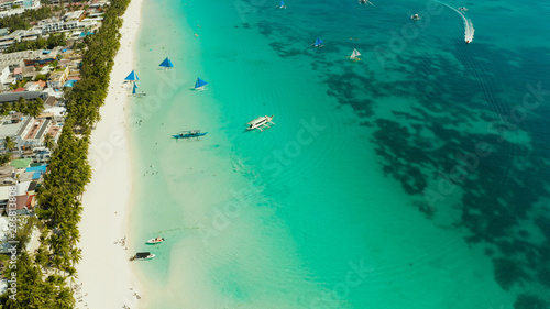 Tropical white sand beach with sailing yachts, hotels near the blue lagoon and corall reef. aerial view, Boracay, Philippines. Seascape with beach on tropical island. Summer and travel vacation © Alex Traveler