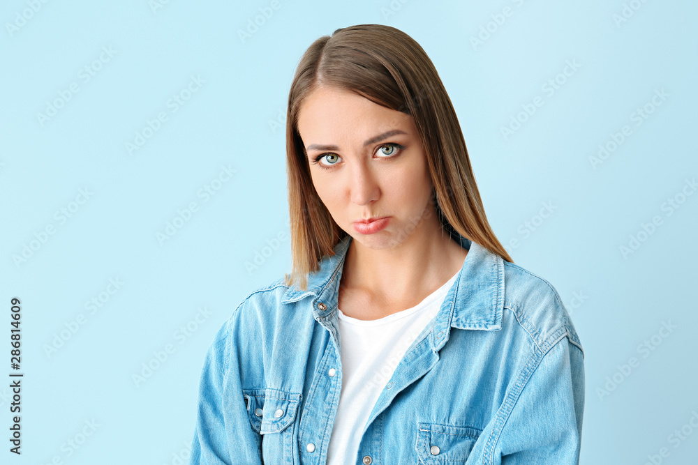 Offended young woman on color background Offended young woman on color background