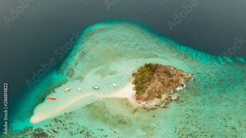 aerial seascape tropical island and sand beach, turquoise water and coral reef. malacory island, Philippines, Palawan. tourist boats on coast tropical island.