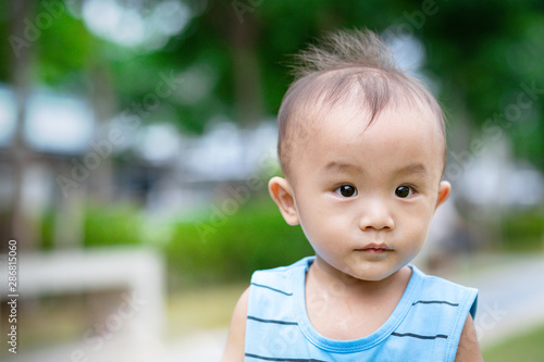 Portrait of little adorable Asian baby boy in park © AlivePhoto