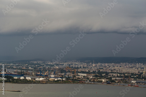 The city of Varna during the storm. The downpour is approaching the sea coast. The Bulgarian resorts in the summer. European recreation area. Thunderhead covers the city.