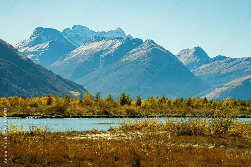 Remarkable scenery invisibly mountain with snow on top and colorful autumn along turquoise Wakatipu Lake, best popular location for tourist and photographer in Glenorchy, South New Zealand.