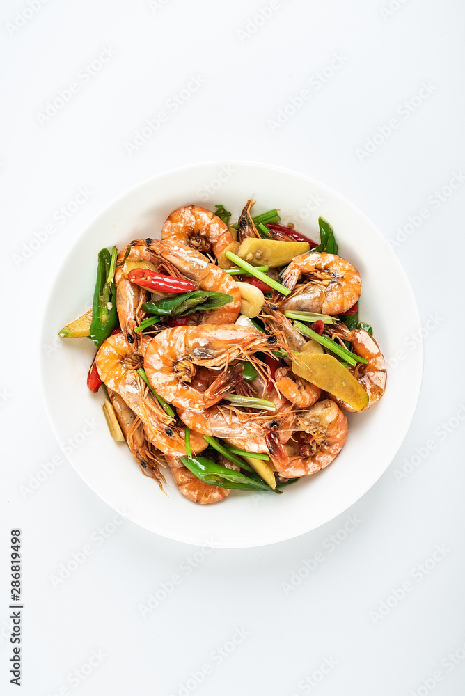 Chinese dish of spicy spicy black shrimp on white background