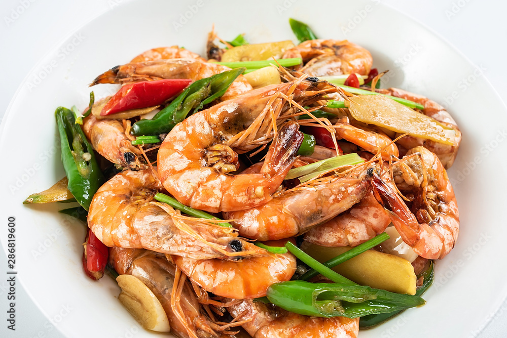 Chinese dish of spicy spicy black shrimp on white background Chinese dish of spicy spicy black shrimp on white background