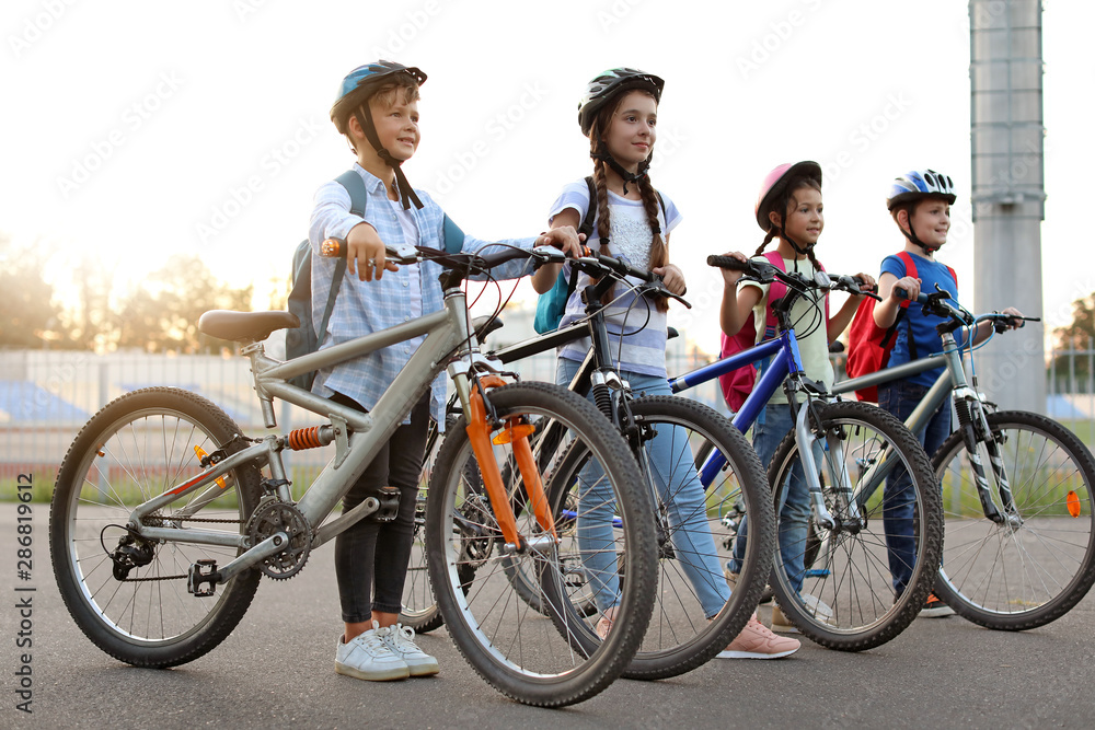 Obraz premium Cute children riding bicycles outdoors