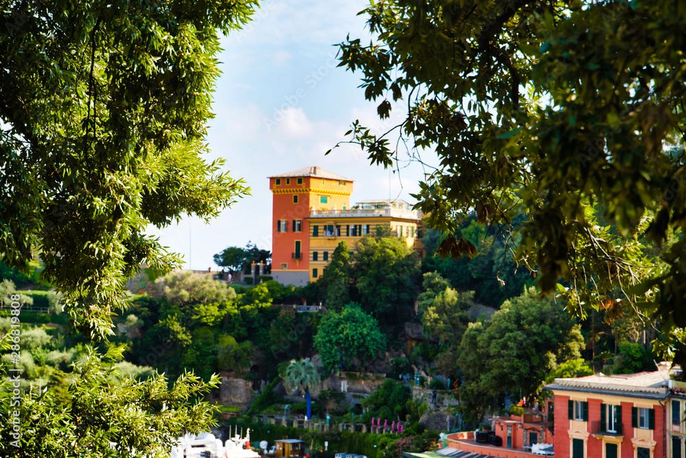 Obraz premium Portofino, Italy - AUGUST 15, 2019: Views of Portofino, a popular resort in Europe / urban architecture among trees / Italian Riviera