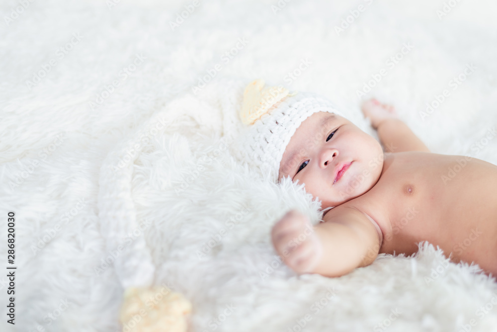 Happy Asian baby lying on white background with copy space Happy Asian baby lying on white background with copy space