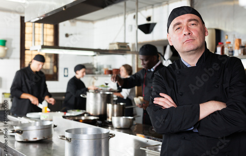 Fototapeta Naklejka Na Ścianę i Meble -  Professional male chef in kitchen of restaurant