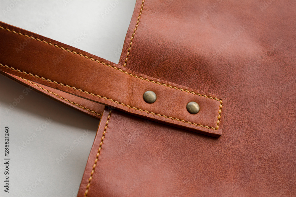 red leather bag with rivets closeup isolated on white background red leather bag with rivets closeup isolated on white background