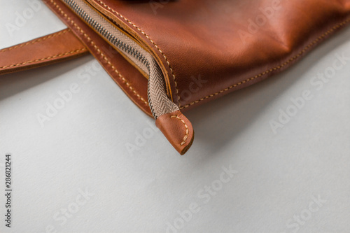 red stitched leather bag close-up on a white background