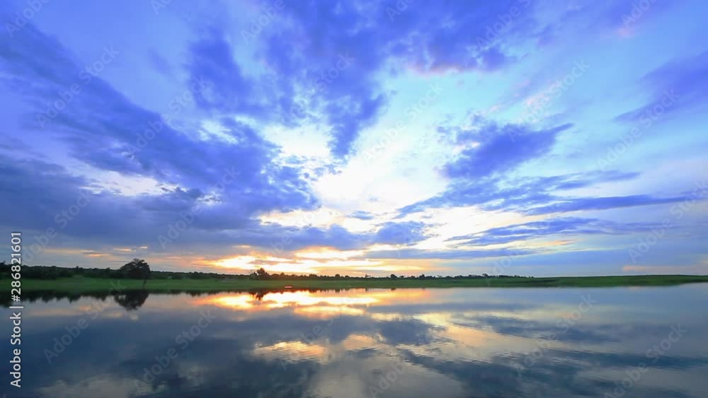 Sunset with cloudy grey and blue skies along the upper reaches of the Chobe river in summer Sunset with cloudy grey and blue skies along the upper reaches of the Chobe river in summer