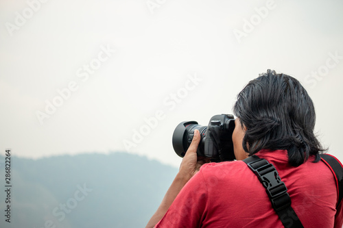 The photographer is photographing the mountain on his travels.