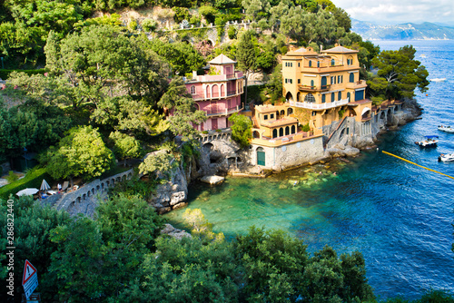 Portofino, Italy - AUGUST 15, 2019: Beautiful harbor in the Italian Riviera, hotels on the cliff, boats on the water / a popular resort in Europe