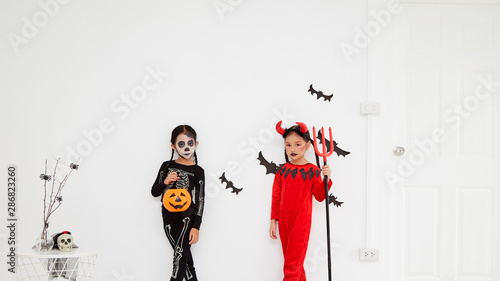 Asian child girls in halloween costumes