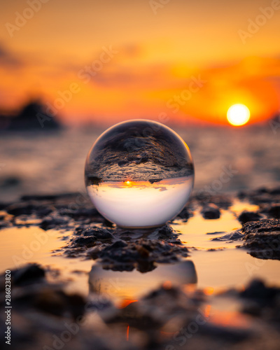 Lensball sunset by the sea