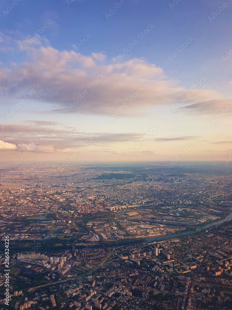 Aerial cityscape view from a plane over St Denis district and Seine river in Paris, France.