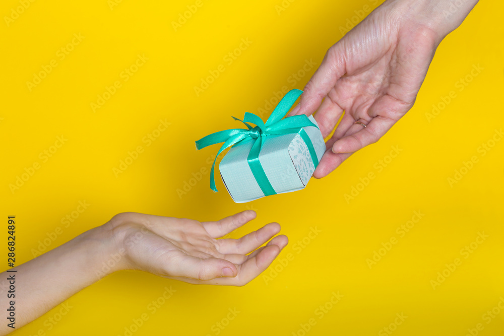 gift is given to the recipient on a yellow background gift is given to the recipient on a yellow background