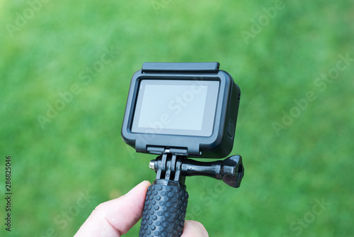 Action camera close-up on stick. Blank screen for mockup.