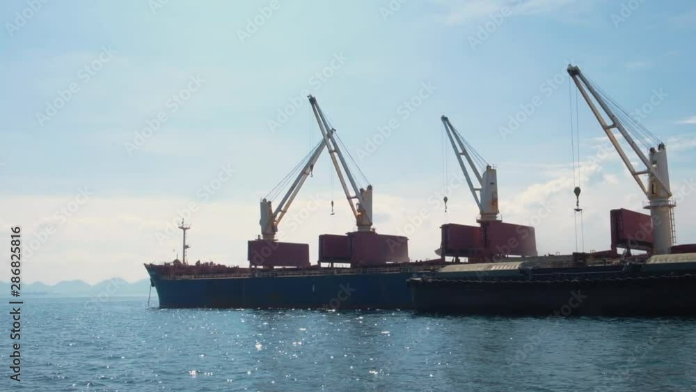View of the cargo container ship. ฺBlue cargo ship View of the cargo container ship. ฺBlue cargo ship