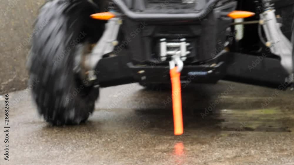 A six-wheeled all-terrain vehicle backs down a path - low angle A six-wheeled all-terrain vehicle backs down a path - low angle