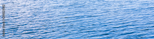 Blue water of ocean lake river sea small waves background texture © Darya