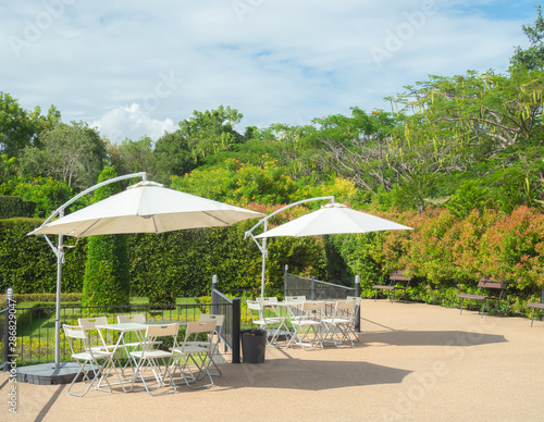 Garden umbrella outdoor with table and chairs in garden