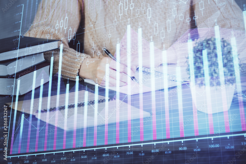 Forex graph on hand taking notes background. Concept of research. Double exposure Forex graph on hand taking notes background. Concept of research. Double exposure