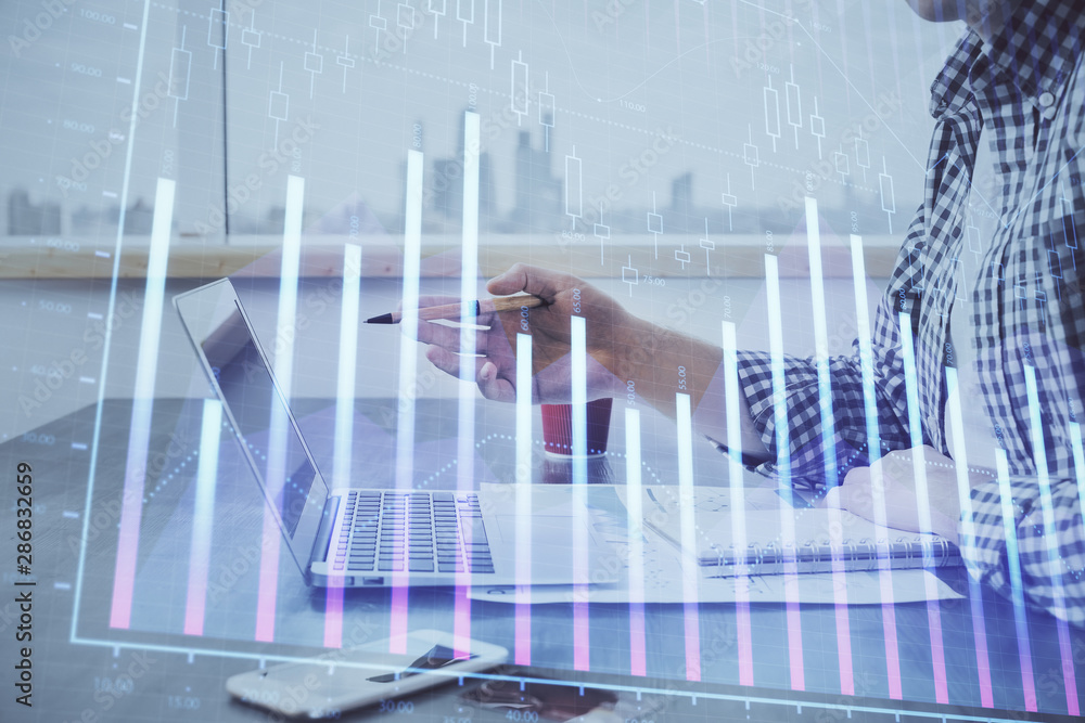 Double exposure of stock market chart with man working on computer on background. Concept of financial analysis. Double exposure of stock market chart with man working on computer on background. Concept of financial analysis.