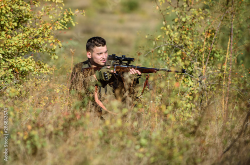 Hunting permit. Hunting is brutal masculine hobby. Hunting equipment for professionals. Bearded serious hunter spend leisure hunting. Hunter hold rifle. Man wear camouflage clothes nature background