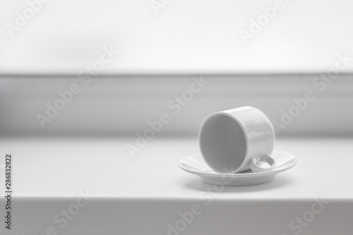 Tableau sur toile Empty white coffee cup on windowsill