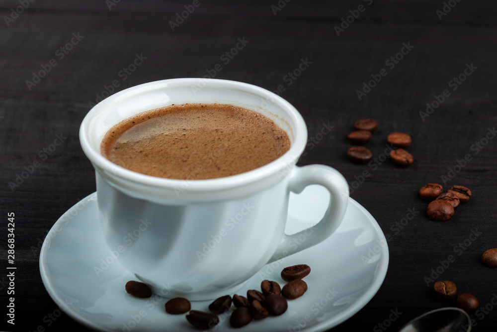 Cup of coffee on a black wooden table Cup of coffee on a black wooden table