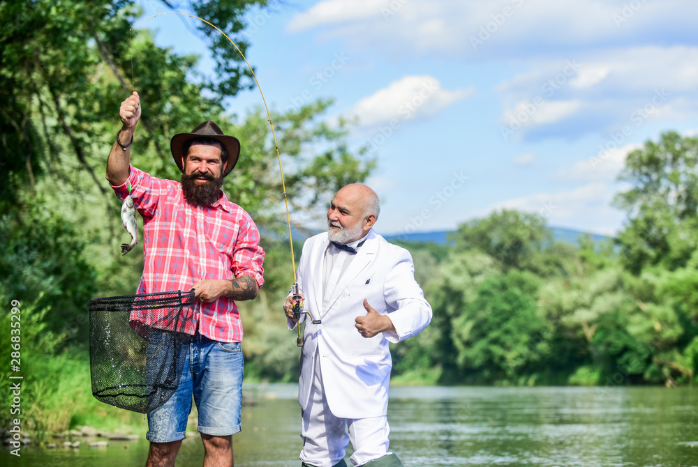 Good catch. Bearded men fishing. Family day. Lucky and skilled. Spinners and tackle. Nice catch
