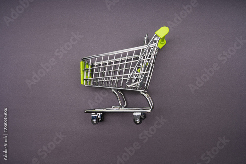 supermarket trolley on yellow background